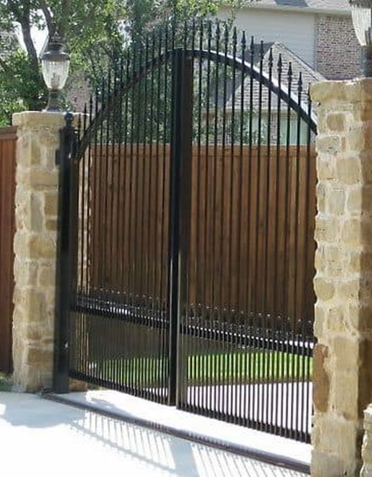Arched Driveway Gate with Stone Pillars